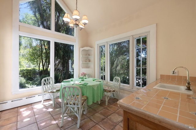 sunroom / solarium featuring sink, a wealth of natural light, a chandelier, and baseboard heating