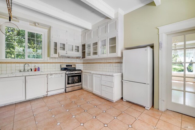 kitchen with tasteful backsplash, white appliances, beam ceiling, and white cabinets