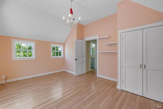 interior space with vaulted ceiling, a notable chandelier, and light hardwood / wood-style floors