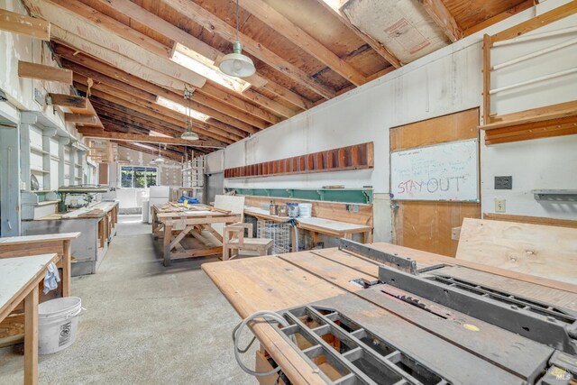 miscellaneous room with lofted ceiling, separate washer and dryer, and a workshop area