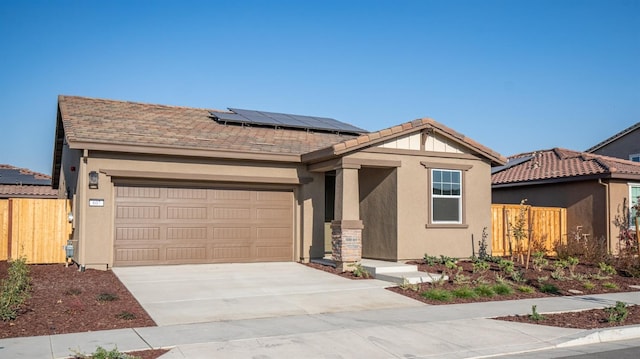 view of front of home featuring a garage and solar panels