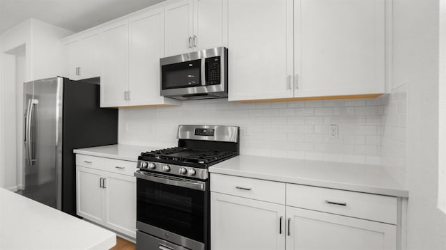 kitchen with white cabinetry, appliances with stainless steel finishes, and tasteful backsplash