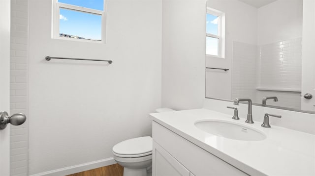 bathroom featuring vanity, toilet, and hardwood / wood-style floors