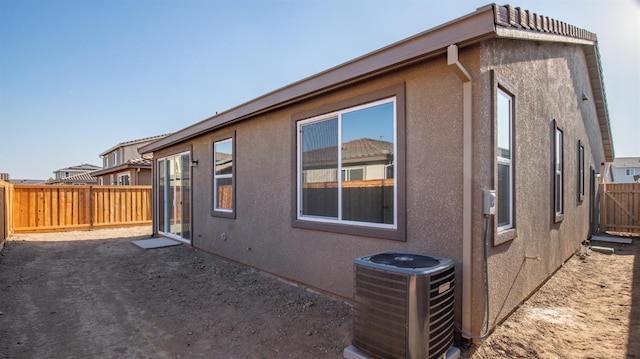 view of side of home with central AC