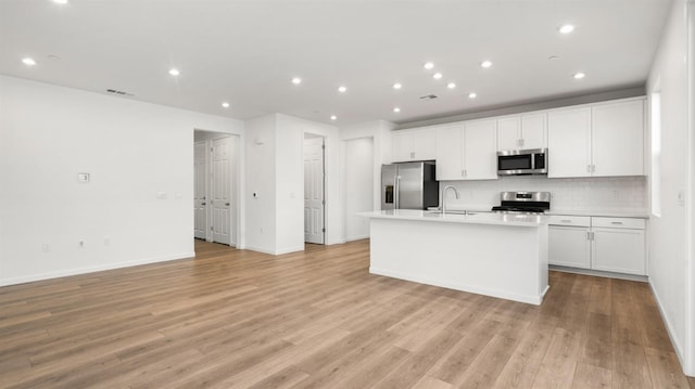 kitchen with white cabinetry, sink, a center island with sink, and appliances with stainless steel finishes