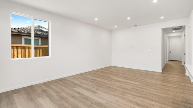 empty room with light hardwood / wood-style flooring