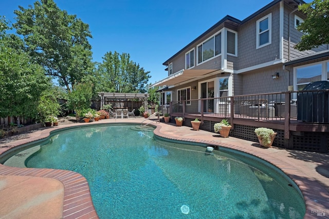 view of swimming pool featuring a patio area and a deck