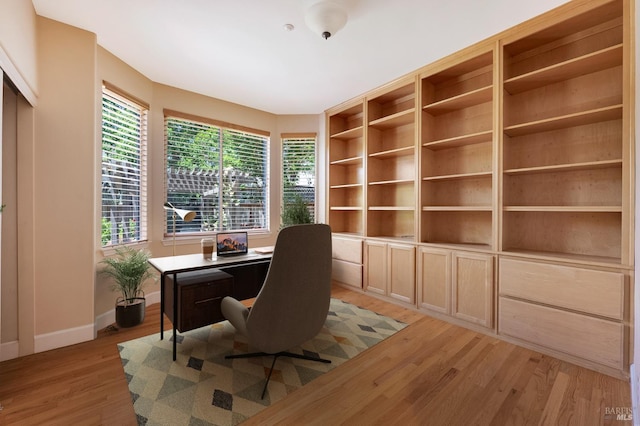 office with baseboards and light wood-type flooring