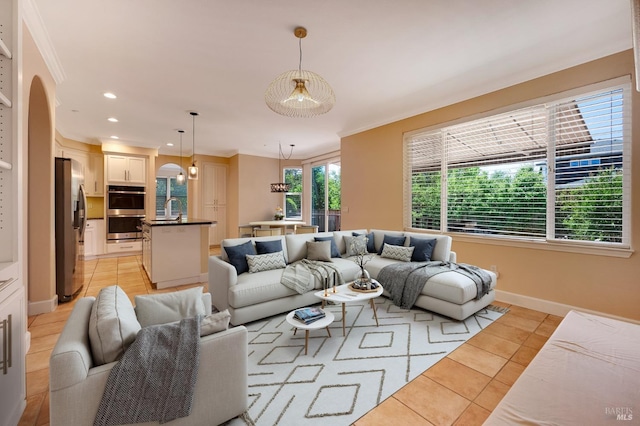 living room featuring light tile patterned floors, arched walkways, and crown molding