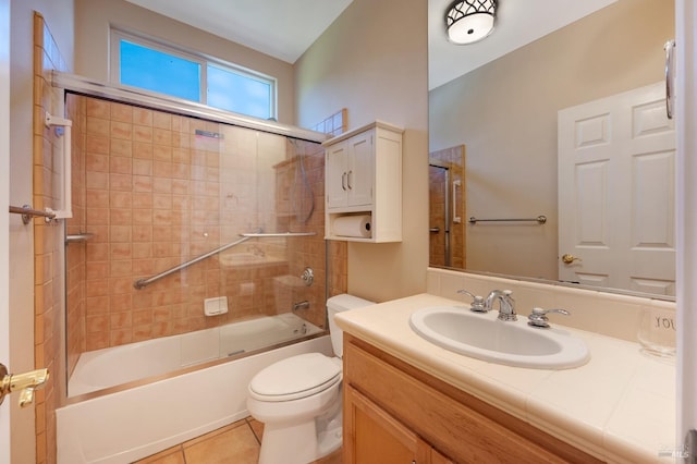 bathroom featuring toilet, vanity, tile patterned floors, and washtub / shower combination
