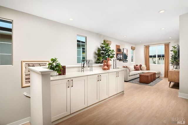 kitchen featuring white cabinetry and light wood-type flooring