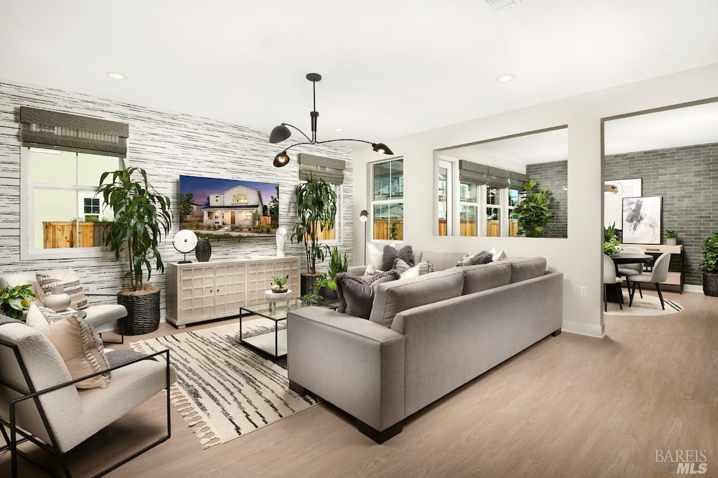 living room featuring light hardwood / wood-style floors and an inviting chandelier