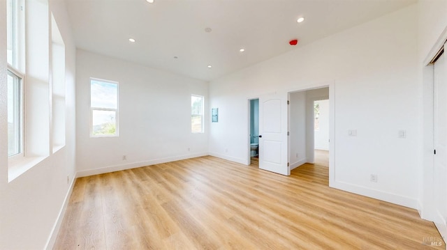 empty room with light hardwood / wood-style flooring