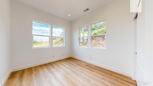 unfurnished room featuring light hardwood / wood-style floors