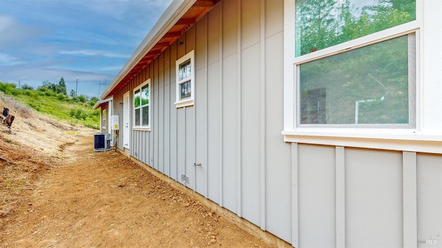 view of side of property with central air condition unit