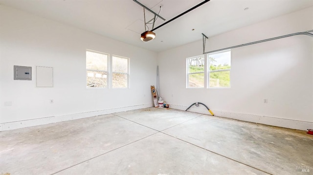 garage with a garage door opener and electric panel