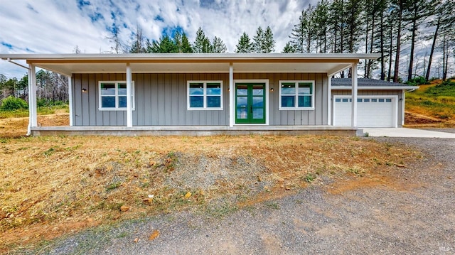 view of front of property with a porch and a garage