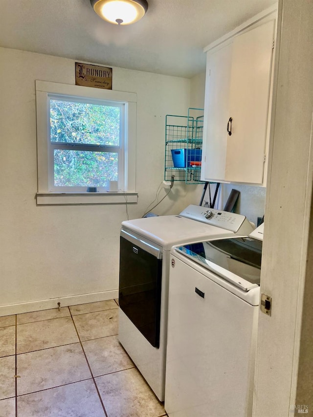 laundry room with cabinet space, baseboards, washer and clothes dryer, and light tile patterned flooring