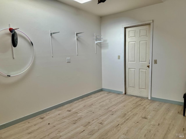 interior space with light wood finished floors and baseboards