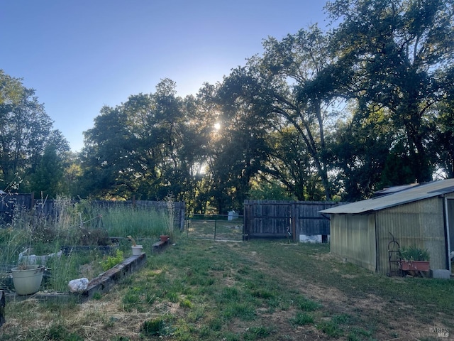 view of yard featuring fence and an outdoor structure