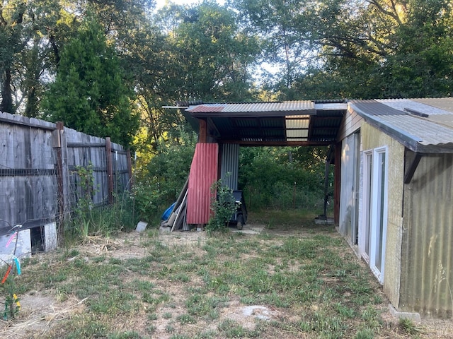 view of yard featuring a carport and fence