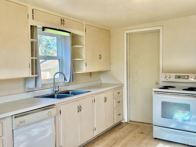 kitchen featuring white appliances, a sink, light wood-style floors, light countertops, and open shelves