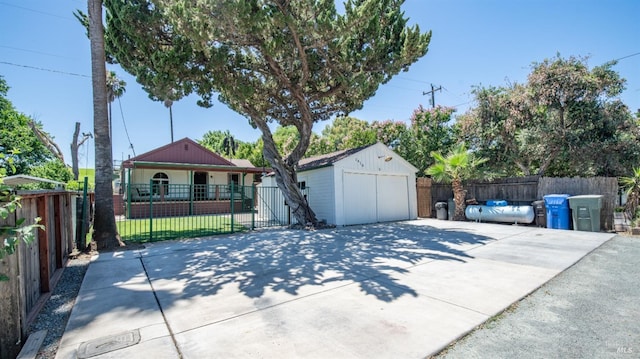 single story home featuring an outbuilding and a garage