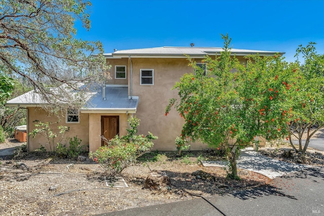 view of front facade with a jacuzzi and stucco siding