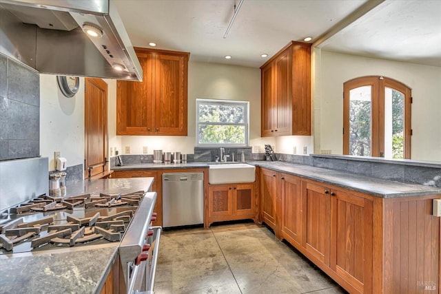 kitchen featuring stainless steel appliances, brown cabinets, a sink, and island range hood