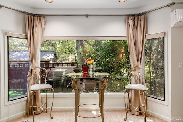 sunroom with a healthy amount of sunlight and a wall mounted AC