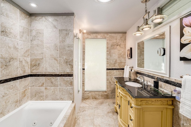 bathroom featuring vanity, tile walls, and tiled tub