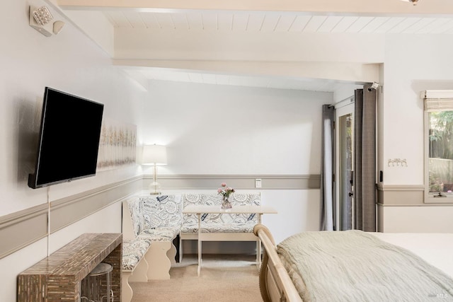 carpeted bedroom featuring beam ceiling and wooden ceiling