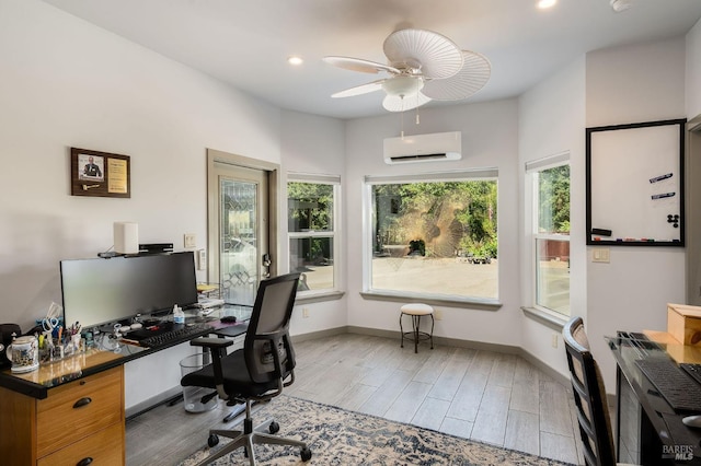 office space featuring light hardwood / wood-style floors, an AC wall unit, and ceiling fan