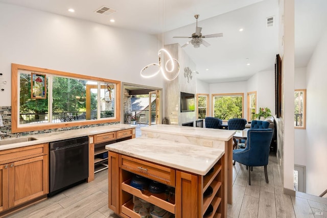 kitchen featuring ceiling fan, a center island, black dishwasher, high vaulted ceiling, and light wood-type flooring