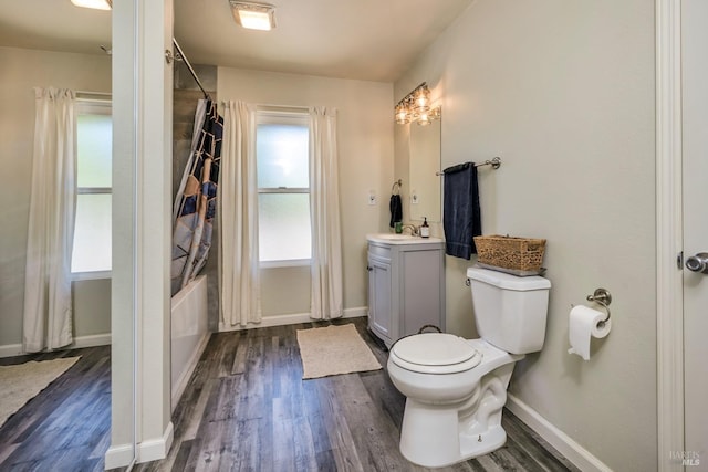 full bathroom featuring shower / bath combination with curtain, vanity, hardwood / wood-style flooring, and toilet