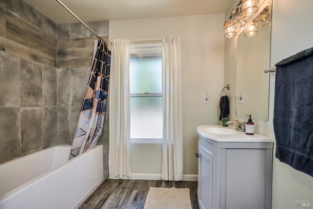 bathroom featuring hardwood / wood-style floors, vanity, a healthy amount of sunlight, and shower / tub combo