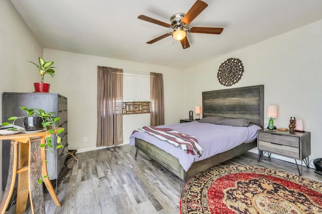 bedroom with wood-type flooring and ceiling fan