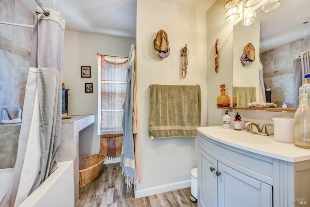 full bathroom with shower / tub combo with curtain, vanity, wood-type flooring, and toilet