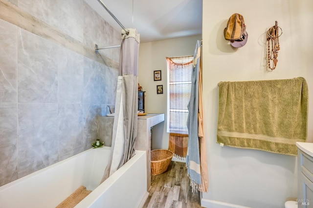 bathroom with vanity, wood-type flooring, and shower / bath combo with shower curtain