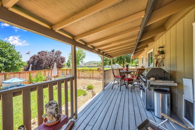 wooden terrace featuring a grill