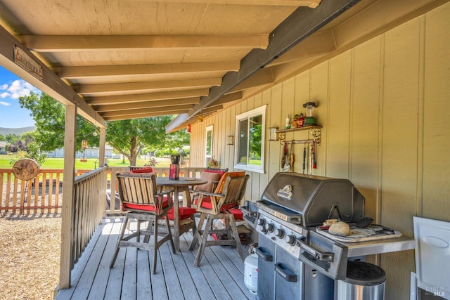 wooden terrace featuring area for grilling