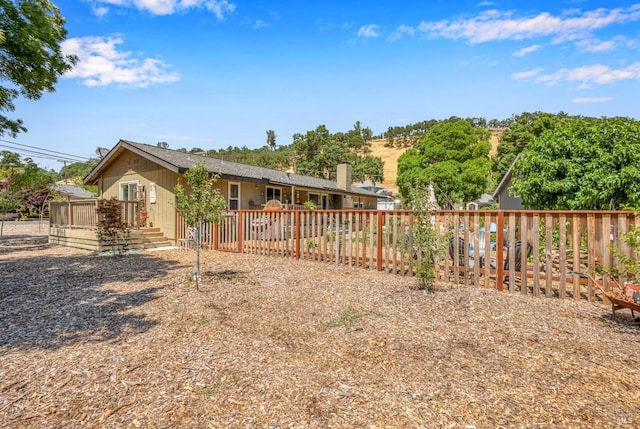 back of house with a wooden deck