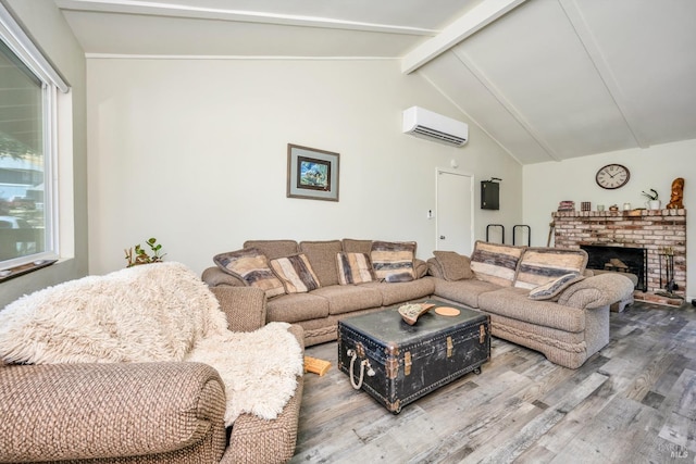 living room featuring a fireplace, hardwood / wood-style floors, lofted ceiling with beams, and a wall unit AC