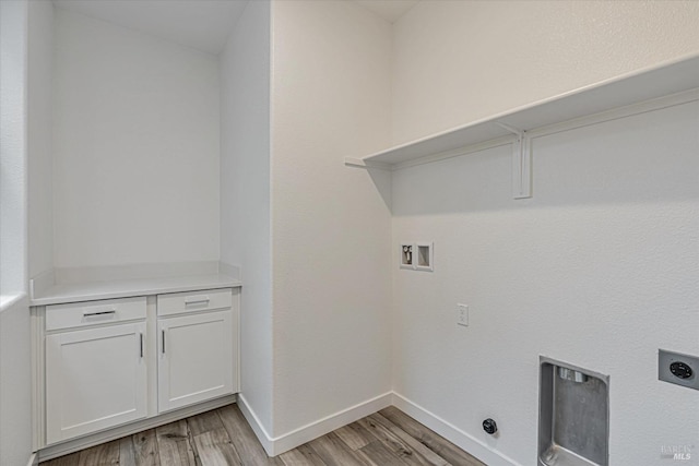 washroom with electric dryer hookup, hookup for a washing machine, and light hardwood / wood-style flooring