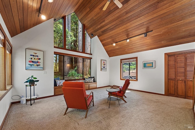 living area featuring wooden ceiling, high vaulted ceiling, rail lighting, carpet flooring, and ceiling fan