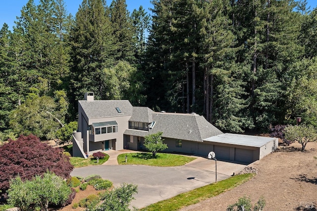 12430 Fiori Ln, Sebastopol, CA 95472 - view of front of property with driveway, a chimney, a garage, and a forest view