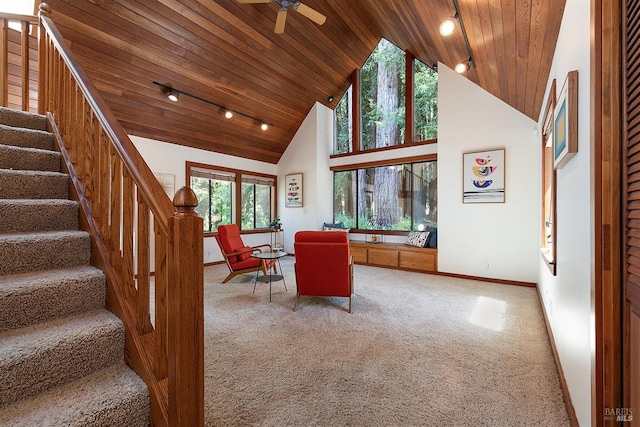 unfurnished living room featuring ceiling fan, carpet, wood ceiling, and high vaulted ceiling