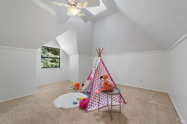 recreation room featuring carpet, ceiling fan, and vaulted ceiling