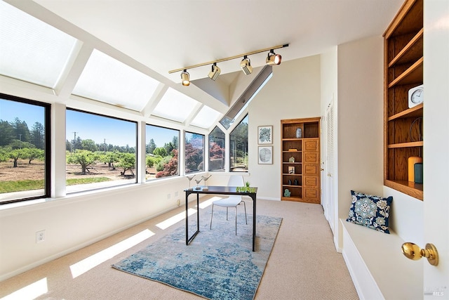 office area featuring light colored carpet and vaulted ceiling