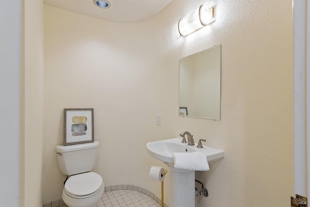 bathroom with tile patterned flooring and toilet